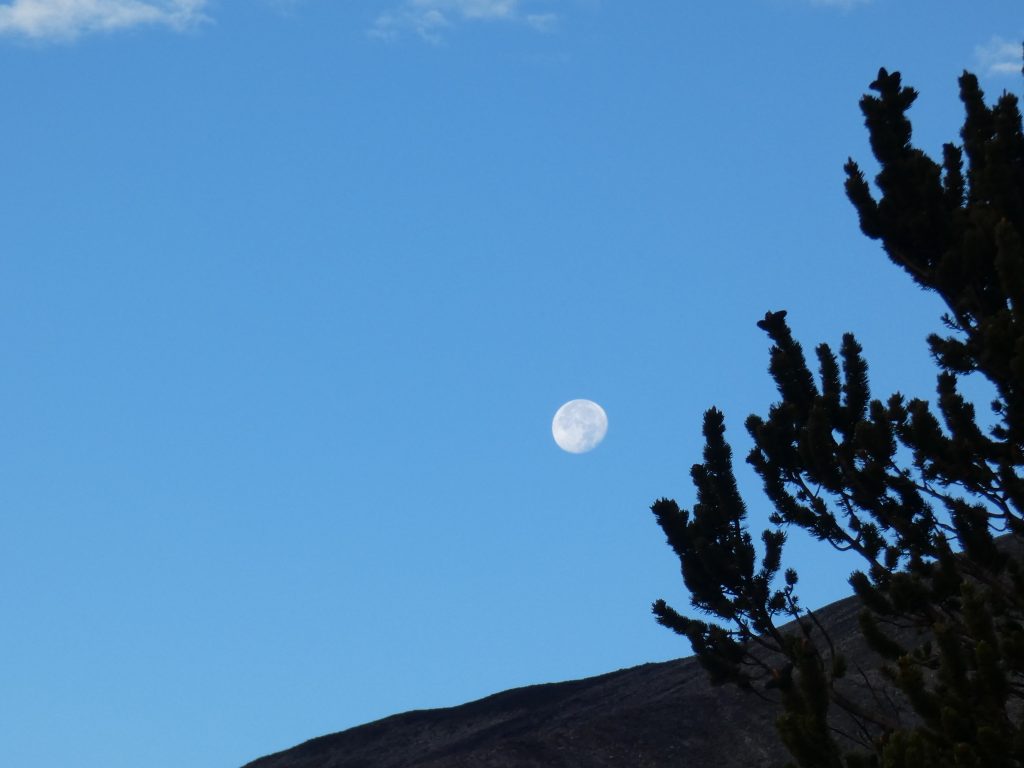 Full moon soon to set behind the ridge